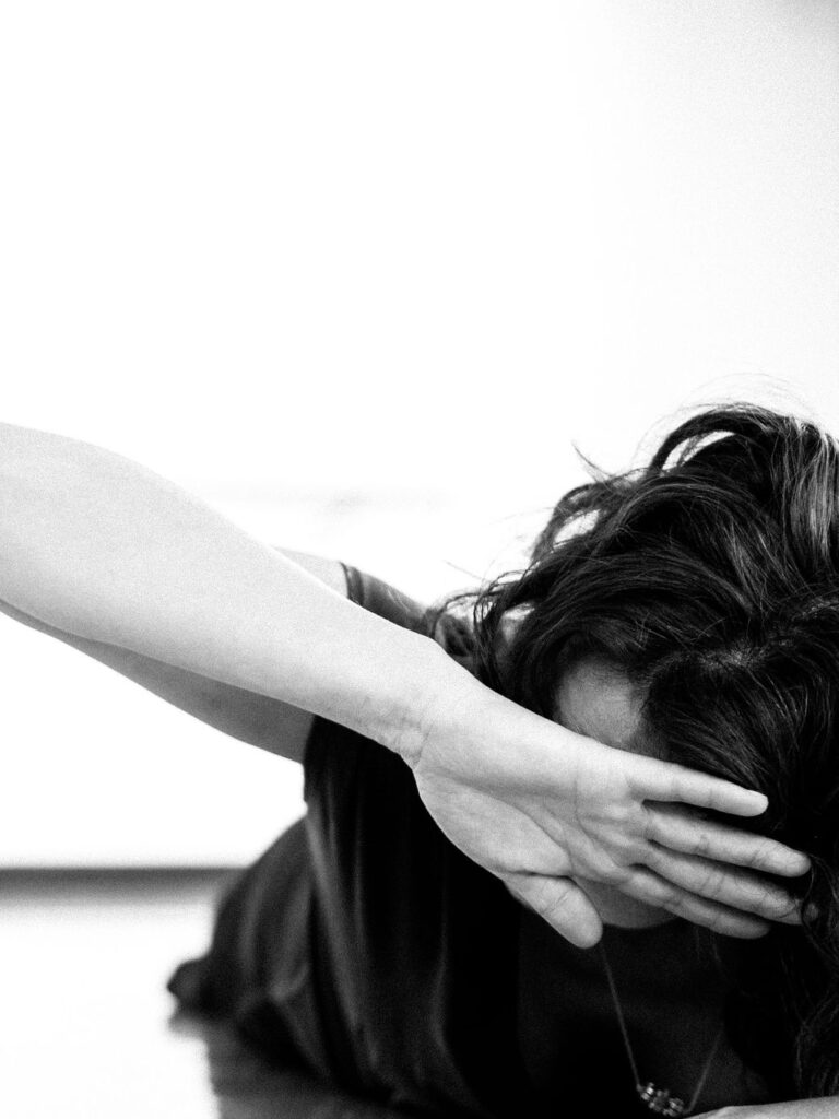 Christine Germain dancing, touching the back of her hand to her forehead